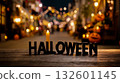 A wooden sign that says HALLOWEEN on a wooden table in front of a city street at night 132601145