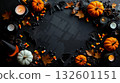A black background with pumpkins candles candy corn and other Halloween decorations 132601151