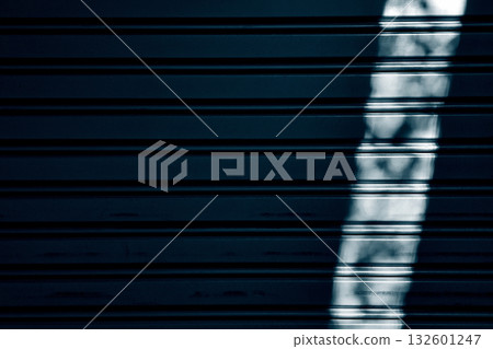 Dark Blue Metallic Roller Shutter Door with Vertical Light Stripe. Dark Blue Metallic Roller Shutter Door with Vertical Light Stripe. 132601247
