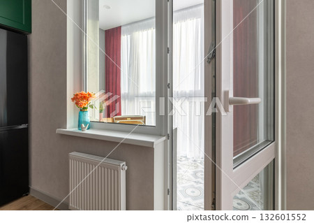 Cozy Kitchen View to Bright Balcony with Open Door 132601552