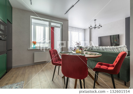 Modern Living Room and Kitchen with Red Chairs and Green Sofa 132601554