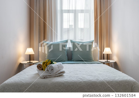 Bright Minimalist Bedroom with Soft Lighting and Elegant Decor Bright Minimalist Bedroom with Soft Lighting and Elegant Decor 132601584
