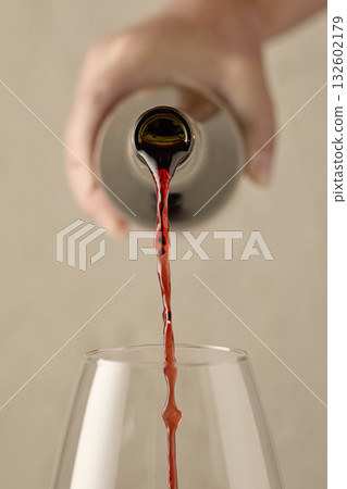 closeup of red wine pouring in glass 132602179