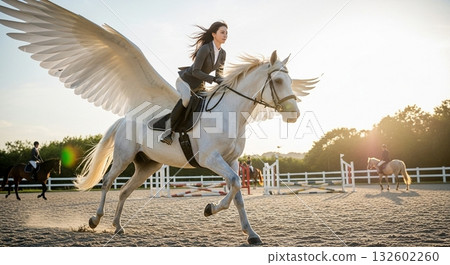 A woman riding a Pegasus on a riding ground at sunset 132602260