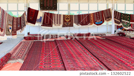 Pavilion selling Turkmen handmade carpets. Handmade carpets with traditional ornament. Turkmenistan. Ashkhabad market. 132602522