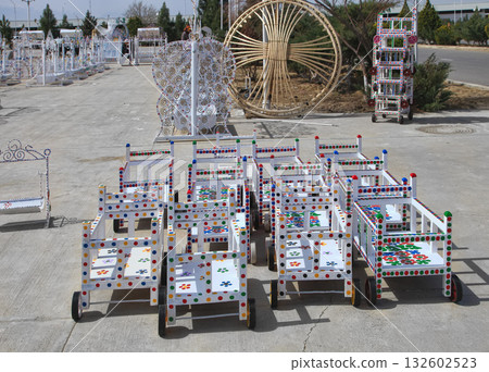 Turkmenistan. Ashkhabad market. Handmade baby carriages with colorful ornaments. 132602523