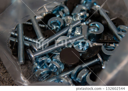 Metal screws and fittings for furniture assembly in plastic bag Metal screws and fittings for furniture assembly in plastic bag 132602544