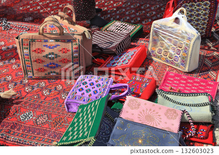 Handmade decorative bags and carpets with traditional ornament. Turkmenistan. Ashkhabad market. Handmade decorative bags and carpets with traditional ornament. Turkmenistan. Ashkhabad market. 132603023