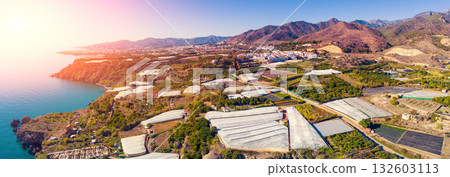 Greenhouses in the south of Spain near Maro city, Nerja, Malaga, Spain. View from a drone. Horizontal banner 132603113
