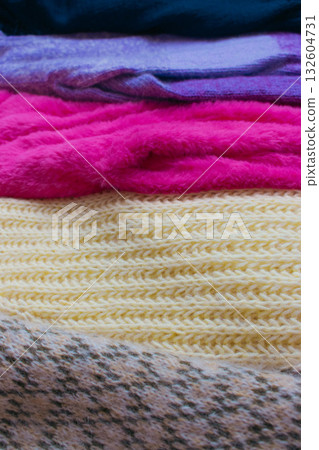 Stack of knitted sweaters. Different knitting patterns. Warm handmade clothes. Knitted sweater cardigans. Craft product concept. Winter fashion. Cozy woven clothing. Knitted fashion. Knitting hobby. Stack of knitted sweaters. Different knitting patterns. Warm handmade clothes. Knitted sweater cardigans. Craft product concept. Winter fashion. Cozy woven clothing. Knitted fashion. Knitting hobby. 132604731
