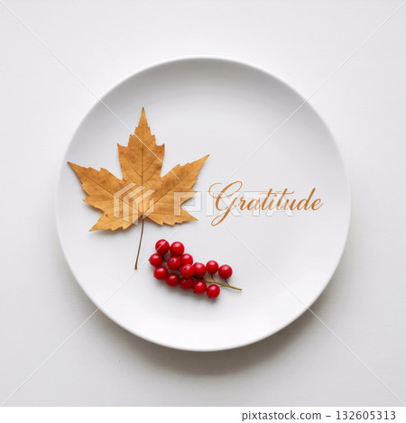 maple leaf and berries on a plate with the word gratitude 132605313