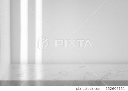 White marble table with a blank wall background and sunlight, ideal for product display. White marble table with a blank wall background and sunlight, ideal for product display. 132606131