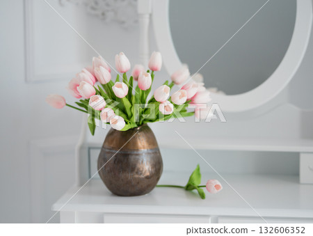 artificial tulips on a table with a mirror 132606352