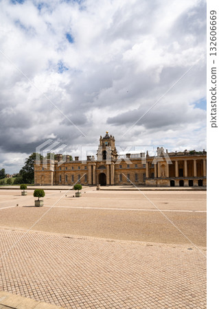 A historic European building with classic baroque architecture, tall arched windows, and stone columns, representing elegant heritage style design. 132606669