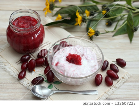 Dessert from cottage cheese and homemade preserved jam from Cornelian cherry dogwood, lat. Cornus mas macrocarpa. Dessert from cottage cheese and homemade preserved jam from Cornelian cherry dogwood, lat. Cornus mas macrocarpa. 132607222