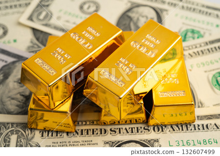 Gold bars on US dollar banknote money, finance trading investment business currency. Gold bars on US dollar banknote money, finance trading investment business currency. 132607499