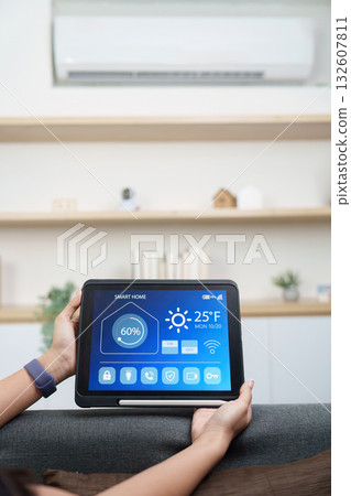 Technology. Woman managing smart home features with tablet. Technology. Woman managing smart home features with tablet. 132607811