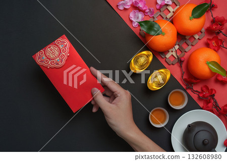 Chinese New Year red envelope with tea and oranges Chinese New Year red envelope with tea and oranges 132608980