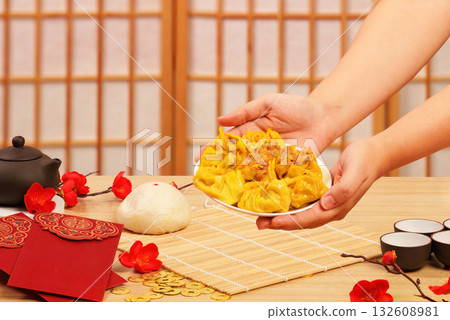 Chinese New Year celebration with dumplings and festive decor Chinese New Year celebration with dumplings and festive decor 132608981