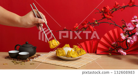 Enjoying dumplings during Chinese New Year celebration Enjoying dumplings during Chinese New Year celebration 132608983