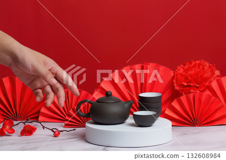 Chinese New Year tea ceremony with elegant teapot and cups Chinese New Year tea ceremony with elegant teapot and cups 132608984