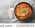 American spaghetti with rich tomato sauce, minced meat, parmesan, green pepper and spices close-up in a plate. Horizontal top view 132609039