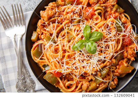 Chicago Style Italian Spaghetti with ground beef, Italian sausage, onions, garlic, tomato and cheese closeup on the plate. Horizontal top view 132609041