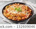 Delicious Chicago spaghetti with spicy tomato sauce, minced meat, parmesan, green pepper and herbs close-up in a plate. Horizontal 132609046