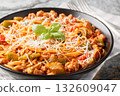 American spaghetti with rich tomato sauce, minced meat, parmesan, green pepper and spices close-up in a plate. Horizontal 132609047