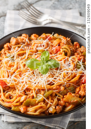 Chicago Spaghetti made with a combination of ground beef, Italian sausage, onions, garlic, and aromatic herbs closeup on the plate. Vertical 132609049