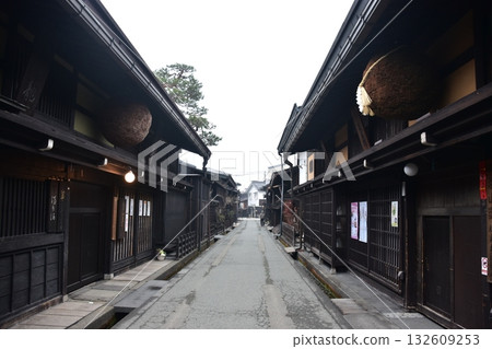 Old townscape of Takayama City, Gifu Prefecture, Japan. A sake shop decorated with cedar balls and an old house with a sense of history. Morning scene during the Takayama Spring Festival. 132609253