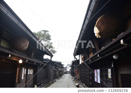Old townscape of Takayama City, Gifu Prefecture, Japan. A sake shop decorated with cedar balls and an old house with a sense of history. Morning scene during the Takayama Spring Festival. Old townscape of Takayama City, Gifu Prefecture, Japan. A sake shop decorated with cedar balls and an old house with a sense of history. Morning scene during the Takayama Spring Festival. 132609256