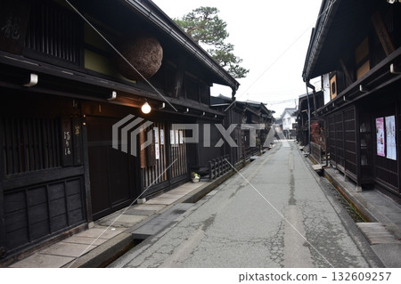 Old townscape of Takayama City, Gifu Prefecture, Japan. A sake shop decorated with cedar balls and an old house with a sense of history. Morning scene during the Takayama Spring Festival. 132609257