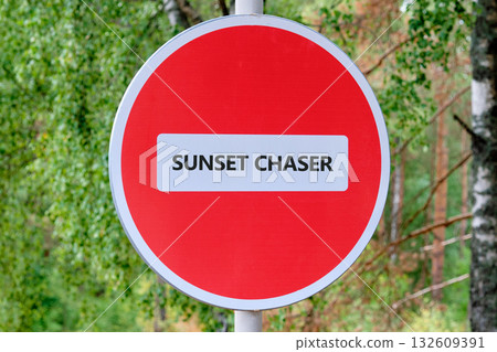 A red circle sign with a white stripe in the middle tells us that it is for Sunset Chasers. Trees and sky in the background. It looks like a secret sign for a club A red circle sign with a white stripe in the middle tells us that it is for Sunset Chasers. Trees and sky in the background. It looks like a secret sign for a club 132609391