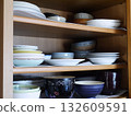 Dishes stored in the cupboard 132609591