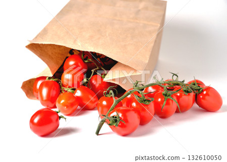 Cherry tomatoes on a branch, paper bag, light background 132610050