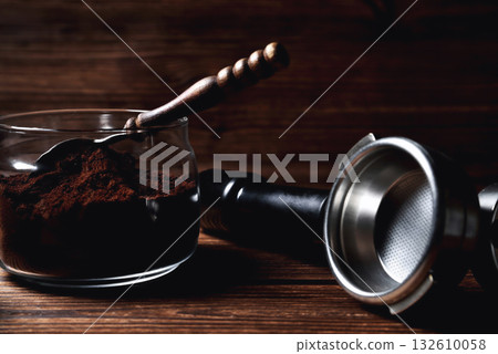 temper portofilter wooden coffee spoon on natural wooden brown background close-up copy space 132610058