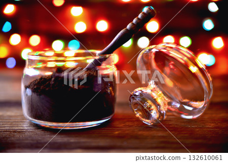 glass jar with ground coffee wooden coffee spoon paper cup on a natural wooden brown background with multi-colored lights blurred plan close-up copy space glass jar with ground coffee wooden coffee spoon paper cup on a natural wooden brown background with multi-colored lights blurred plan close-up copy space 132610061