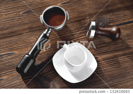 white coffee cup with a saucer barista accessories for making coffee temper and a coffee horn wooden natural background 132610083