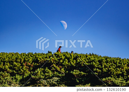 The moon and climbers in the blue sky - on the ridge of Mount Daisetsu 132610190