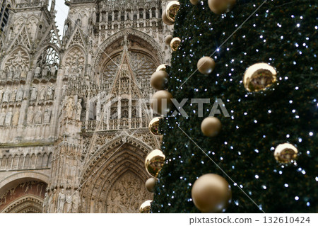 A big cathedral in Rouen with a decorated Christmas tree 132610424