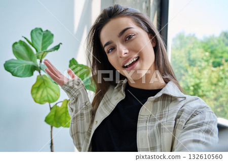Close-up selfie portrait of teenage female looking at web camera Close-up selfie portrait of teenage female looking at web camera 132610560