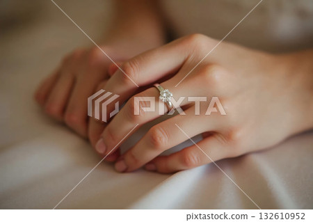 Woman's hand wearing a ring 132610952