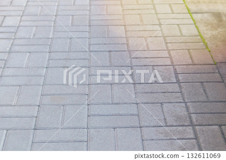 Paving slab. Grey background. Pedestrian zone in park in sunny daylight. Paving slab. Grey background. Pedestrian zone in park in sunny daylight. 132611069