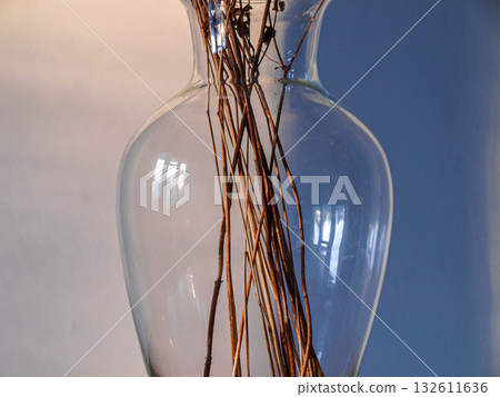 Glass vase and stems of dried flowers art poster 132611636
