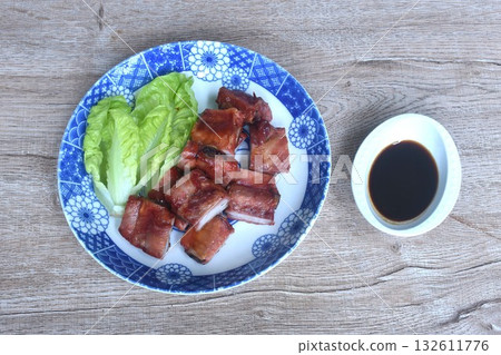 fried crispy pork bone or rib with baby cos lettuce on plate dipping black sweet sauce cup fried crispy pork bone or rib with baby cos lettuce on plate dipping black sweet sauce cup 132611776