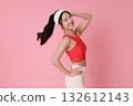 Fitness woman smiling in red sports top on pink background for healthy lifestyle beauty and activewear advertising mockup 132612143