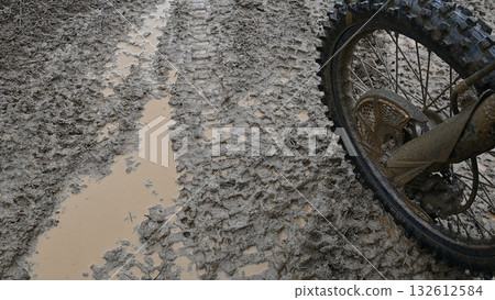 Muddy ground and bike after the rain Muddy ground and bike after the rain 132612584