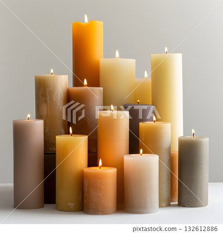 Collection of burning pillar candles in warm neutral colors on a minimal background. Cozy light, soft wax texture, calm mood. Collection of burning pillar candles in warm neutral colors on a minimal background. Cozy light, soft wax texture, calm mood. 132612886