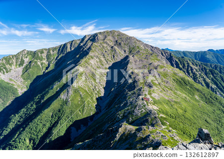 Mt. Ainotake seen from the hiking trail to Mt. Nishinotori. Climbing Mt. Ainotake and Mt. Notori of the Shiramine Sanzan mountains in the Southern Alps. Mt. Ainotake seen from the hiking trail to Mt. Nishinotori. Climbing Mt. Ainotake and Mt. Notori of the Shiramine Sanzan mountains in the Southern Alps. 132612897